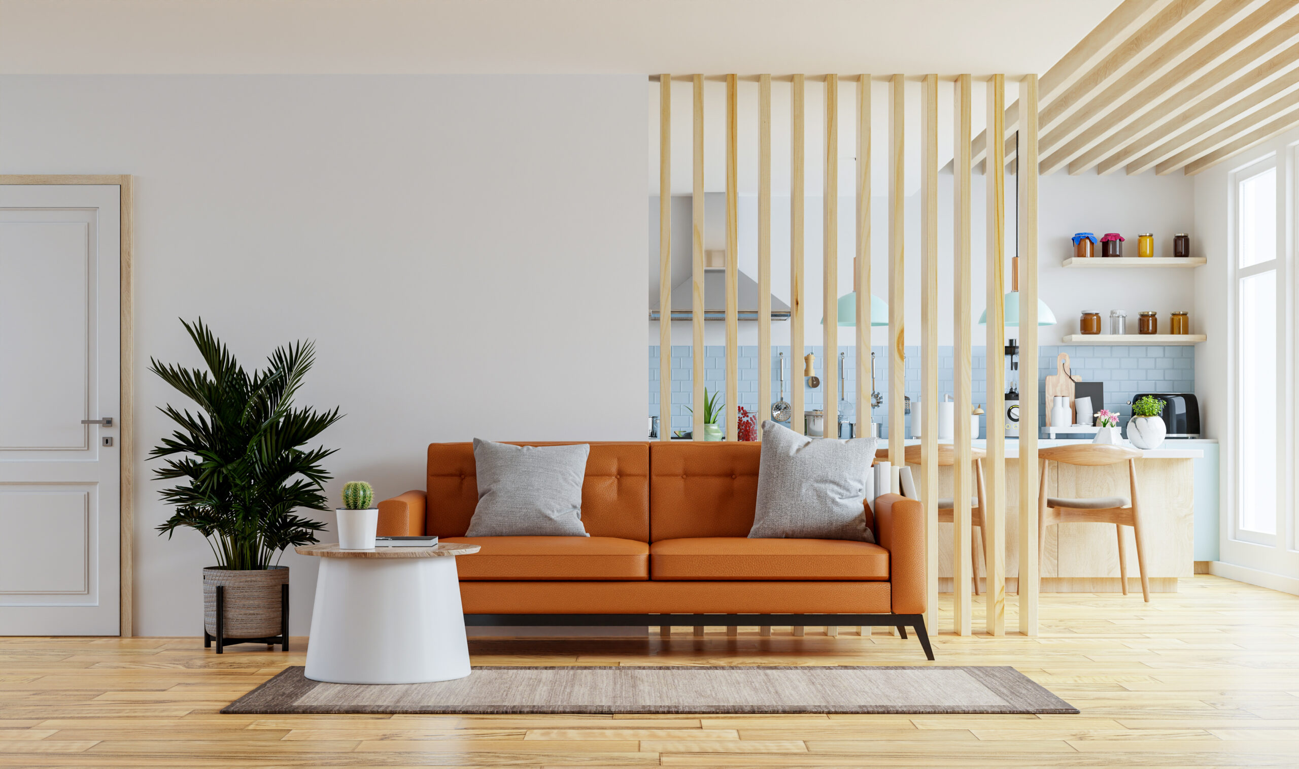 Living room interior wall mockup in warm tones with leather sofa which is behind the kitchen.3d rendering